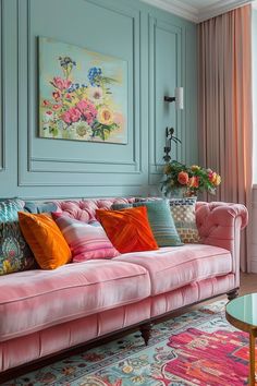 a living room filled with pink couches and colorful pillows