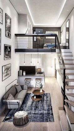 a living room filled with lots of furniture and pictures on the wall next to stairs