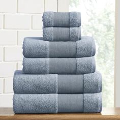 a stack of blue towels sitting on top of a wooden table