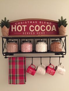 a shelf with coffee mugs and hot cocoa on it