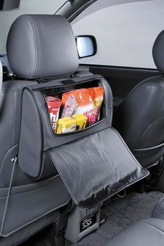 the back seat is filled with snacks and other things to put in it's pocket