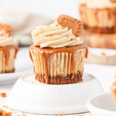 cupcakes with peanut butter frosting and cookies on the top are ready to be eaten