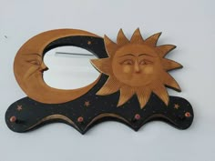 a sun and moon shaped mirror hanging on the wall