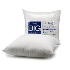 the big pillow is sitting next to two pillows