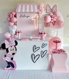 a minnie mouse birthday party with balloons and decorations