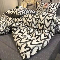 black and white bedding with hearts on the pillowcase in a store display room