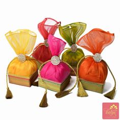 four small bags with tassels on them