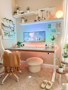 a desk with a computer on it in a room filled with plants and other things