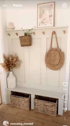 a white bench with baskets hanging on it