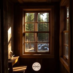 the sun shines through a window in a cabin