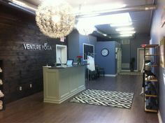 the inside of a shoe store with wood floors and chandelier hanging from the ceiling