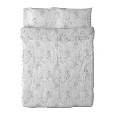 a white comforter with floral print on the sheets and pillowcases, in front of a white background