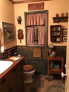 a bathroom with a toilet, sink, and window in the wall next to it