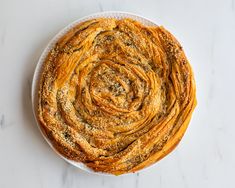 a white plate topped with bread on top of a table