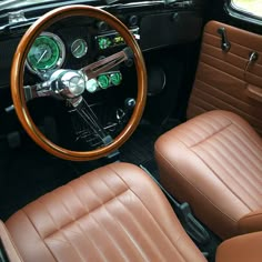 the interior of an old car with brown leather seats and steering wheel, including gauges