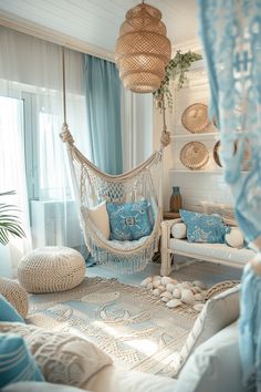 a living room filled with lots of white furniture and blue pillows on top of it