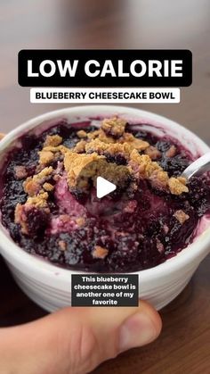 a person holding a bowl of blueberry cheesecake bowl