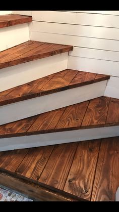 some wooden steps in front of a white wall