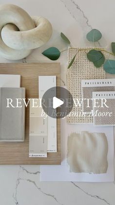 some white paint and other items on top of a marble table with the words revel water