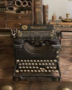 an old fashioned typewriter sitting on top of a wooden table