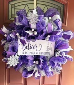 This beautiful purple and silver wreath will look gorgeous on your door or wall, or would make the perfect Christmas or housewarming gift.   The wreath is made from high quality silver and vibrant purple deco mesh. I've added four different coordinating ribbons, including a glittery silver snowflake ribbon. Purple and silver glitter balls have been added for extra depth and detail. The center sign is hand painted and matches the colors of the wreath. The dimensions are approximately 26" wide and 27" long. It is about 7" deep. This is a large, full wreath and may not fit between all storm doors. Click here to see more of my Christmas wreaths: https://www.etsy.com/shop/WilliamStreetWreaths?ref=simple-shop-header-name&listing_id=1066249014§ion_id=35261564 All of my wreaths are handmade and un Christmas Wreaths Purple, Purple And Silver Christmas Tree Ideas, Purple Christmas Aesthetic, Purple And Silver Christmas, Purple Christmas Wreath, Silver Christmas Wreath, Snowflake Ribbon, Purple Christmas Decorations, Aesthetic Whimsical