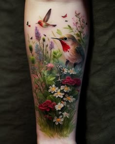 a woman's leg with flowers and birds on it