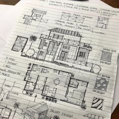 a drawing of a house on top of a piece of paper with some drawings in front of it