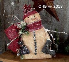 a snowman statue sitting on top of a wooden table