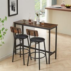 a kitchen table with two stools next to it