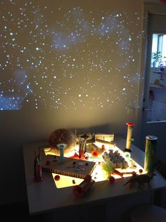 an image of a room with stars on the wall and various objects in front of it