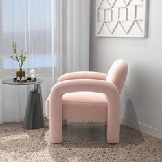 a pink chair sitting in front of a window next to a table with a vase on it