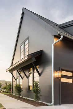 an image of a house that is in the process of being painted gray and white