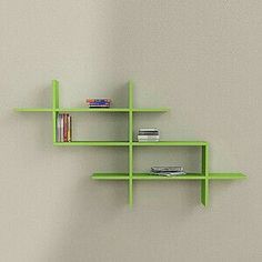 a wooden shelf with books on it against a wall in a room that has a chair and table