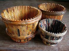 three woven baskets sitting on top of a wooden table