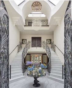 the entry hall is decorated with glass vases and chandeliers, as well as an ornate staircase