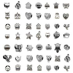 many different types of buttons on a white background, including one with an animal and two with hearts