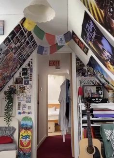 the hallway is decorated with posters, pictures, and guitar string art hanging from the ceiling