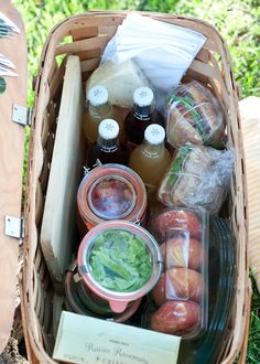 a picnic basket filled with food and condiments