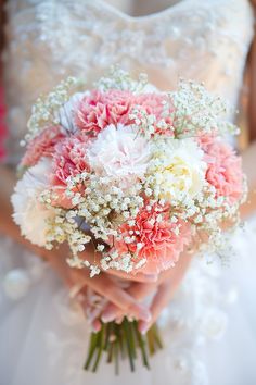 a bridal holding a bouquet of pink and white flowers