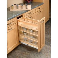 an open drawer in the middle of a kitchen