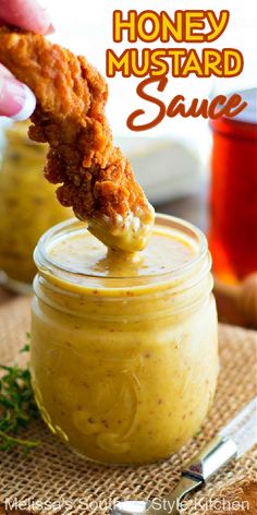 a person dipping something into a jar with the words honey mustard sauce on it and an image