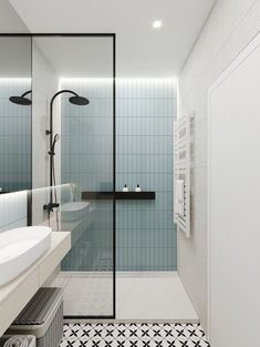 a bathroom with black and white tiles on the floor, shower stall and sink area