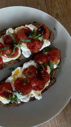 two slices of bread topped with tomatoes and cheese