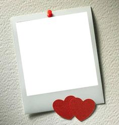 two red hearts pinned to a white photo frame