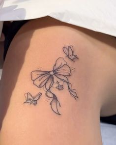 a woman with a tattoo on her stomach has butterflies flying around her thigh and the lower half of her leg