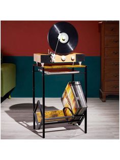 an old record player on a table with vinyl records