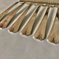 six forks are lined up on a table