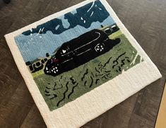 a rug with a car on it sitting on the floor