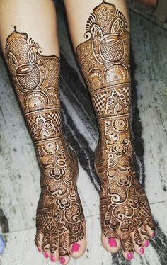 the feet are decorated with henna designs