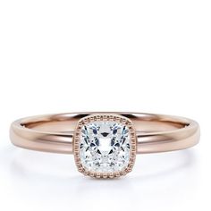 a rose gold engagement ring with a cushion cut diamond in the center